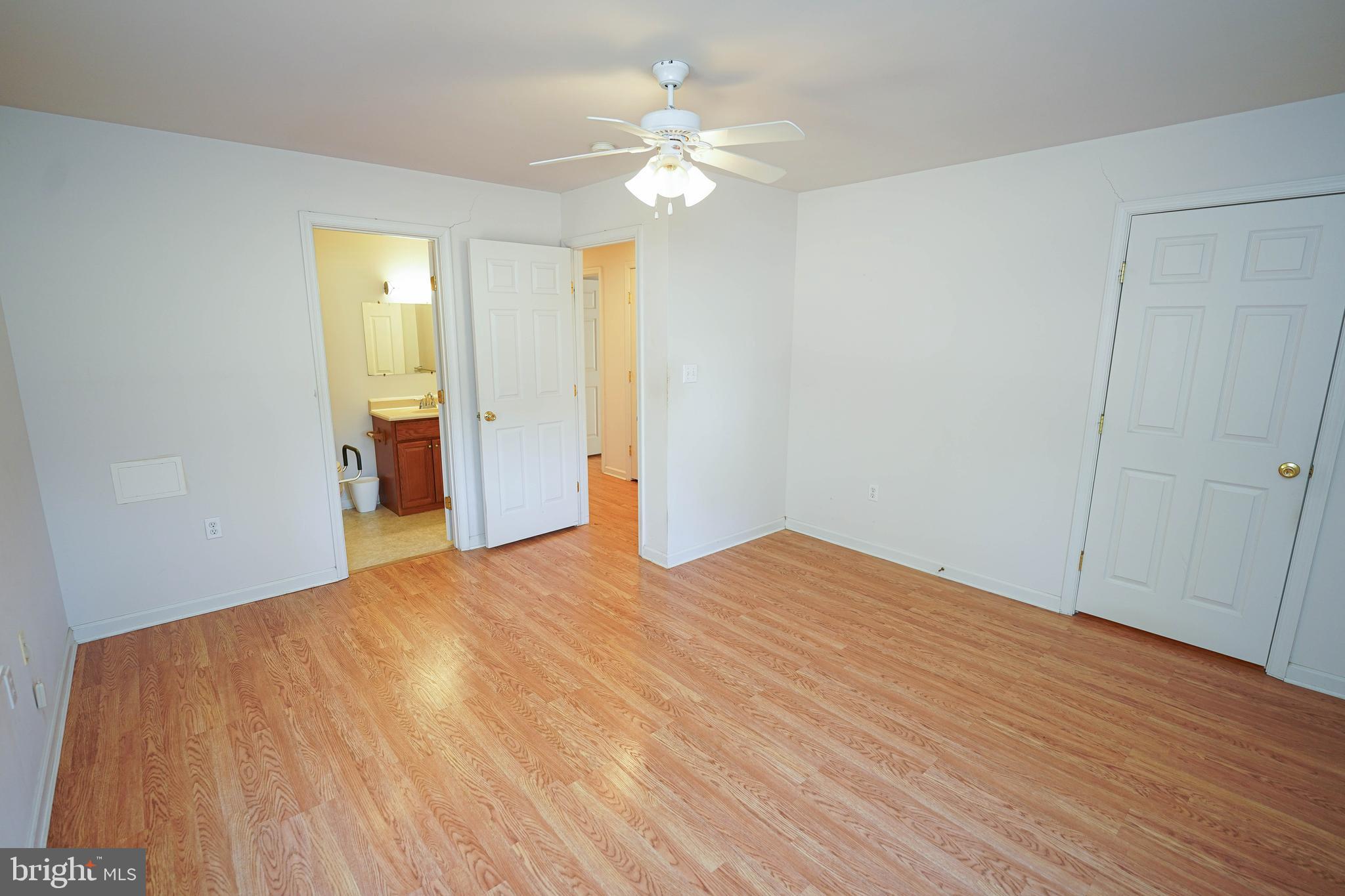 23290 Custom House Road Deal Island, MD 21821 - Photo 24 of 64 a bedroom with a bed and a chandelier
