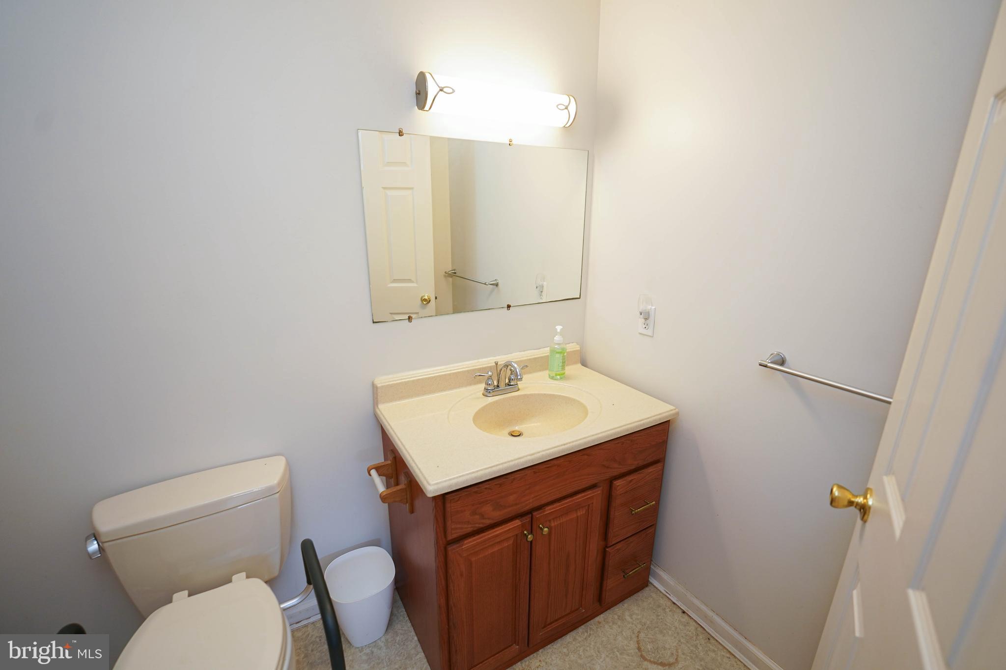 23290 Custom House Road Deal Island, MD 21821 - Photo 27 of 64 a bathroom with a toilet sink and mirror
