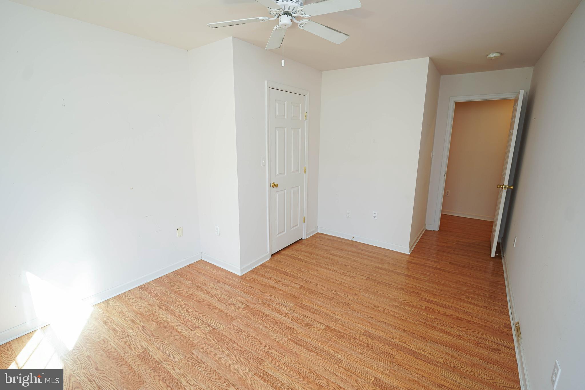 23290 Custom House Road Deal Island, MD 21821 - Photo 37 of 64 a view of a bedroom with wooden floor and a ceiling fan