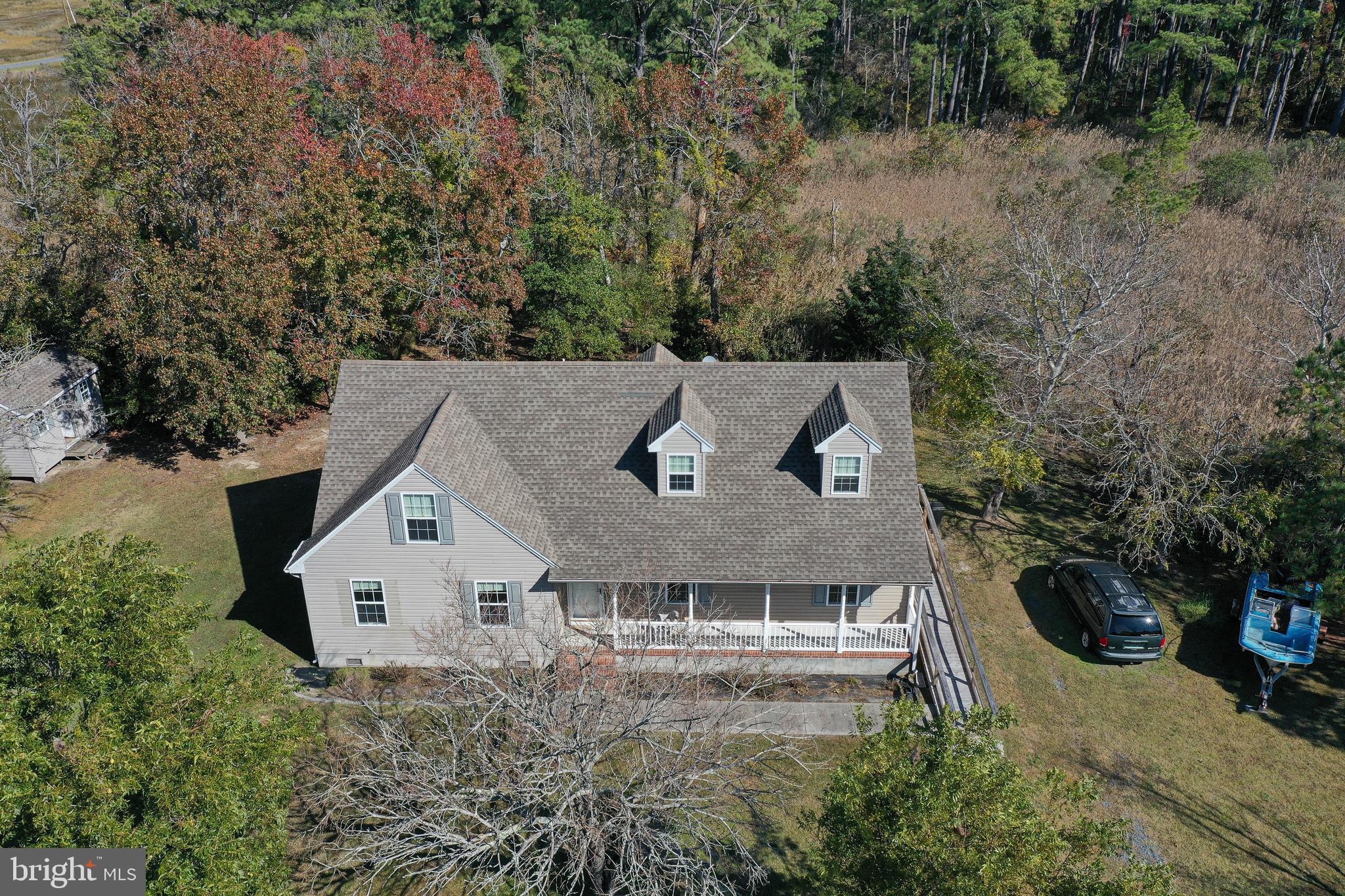 23290 Custom House Road Deal Island, MD 21821 - Photo 58 of 64 an aerial view of a house with yard and trees in the background