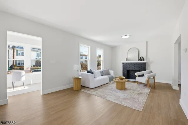 a living room with fireplace furniture and a wooden floor