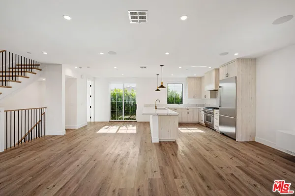 a large kitchen with a table and chairs