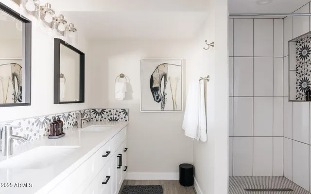 a bathroom with a sink vanity and mirror