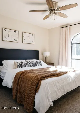 a bedroom with a bed and lamp