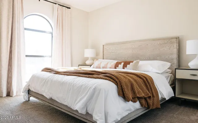 a bedroom with a bed and a mirror