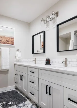 a bathroom with a double vanity sink and a mirror