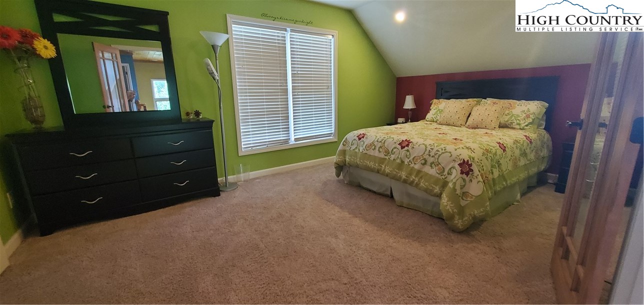 292-294 Wildcat Ridge Road Deep Gap, NC 28618 - Photo 26 of 49 a bedroom with a bed and a mirror