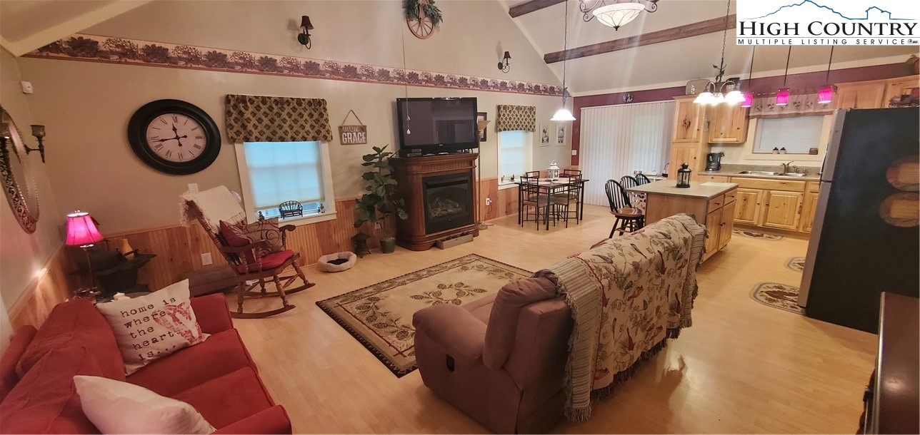 292-294 Wildcat Ridge Road Deep Gap, NC 28618 - Photo 45 of 49 a living room with furniture a clock and a window