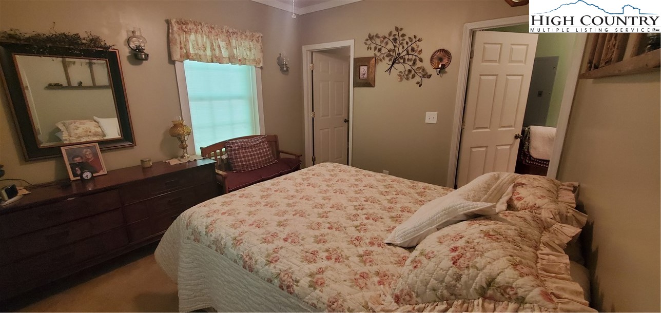 292-294 Wildcat Ridge Road Deep Gap, NC 28618 - Photo 46 of 49 a bedroom with a bed and a mirror