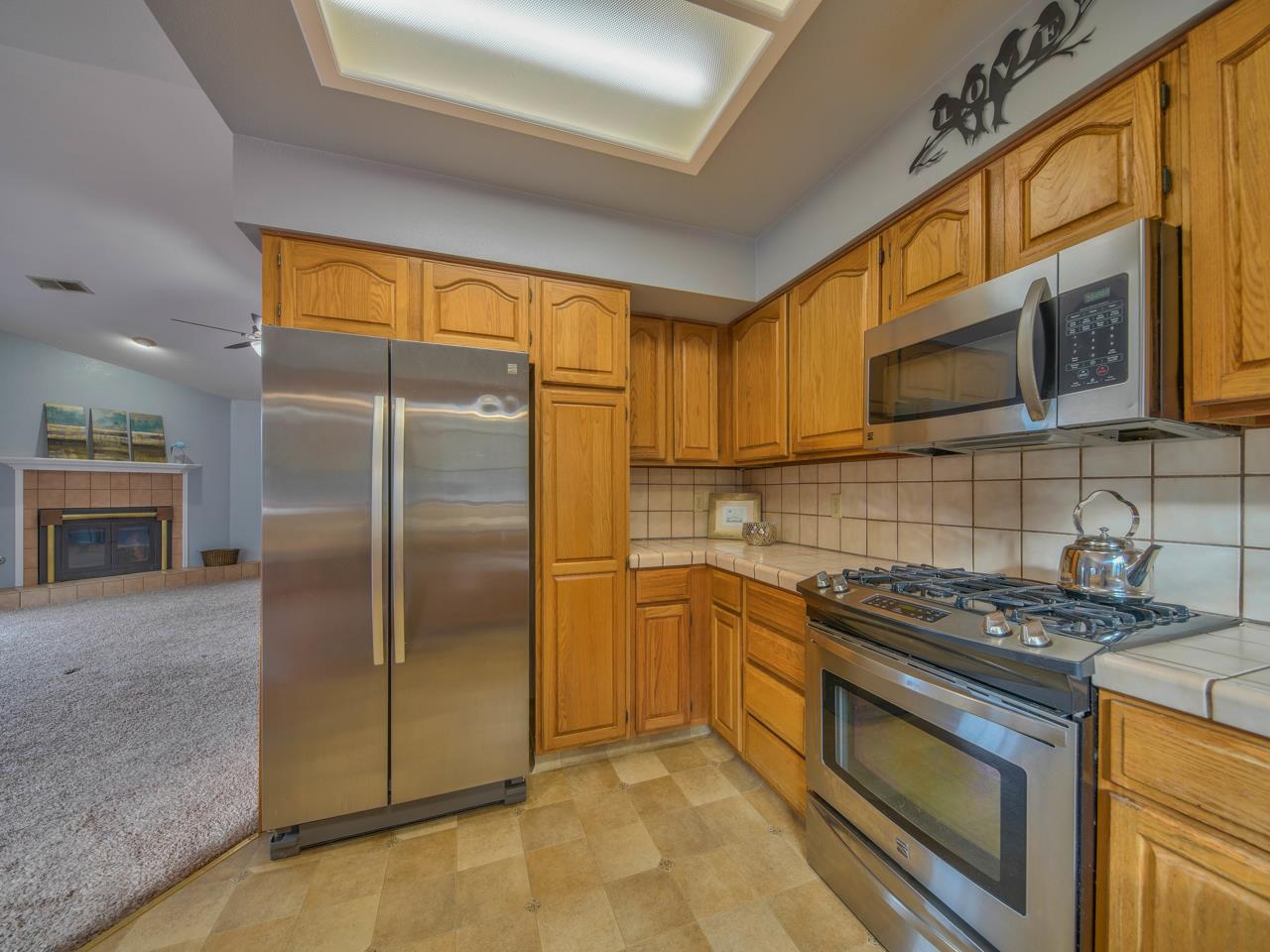 6640 Kim Ann Lane Salinas, CA 93907 - Photo 15 of 41 a kitchen with stainless steel appliances granite countertop a refrigerator a stove and a sink with cabinets