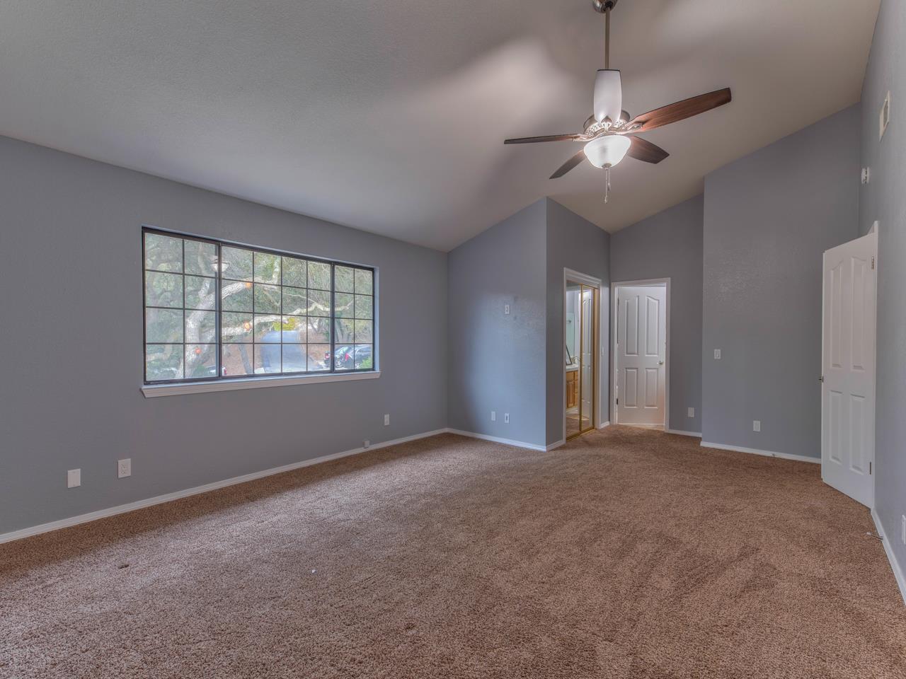 6640 Kim Ann Lane Salinas, CA 93907 - Photo 19 of 41 an empty room with chandelier fan and windows