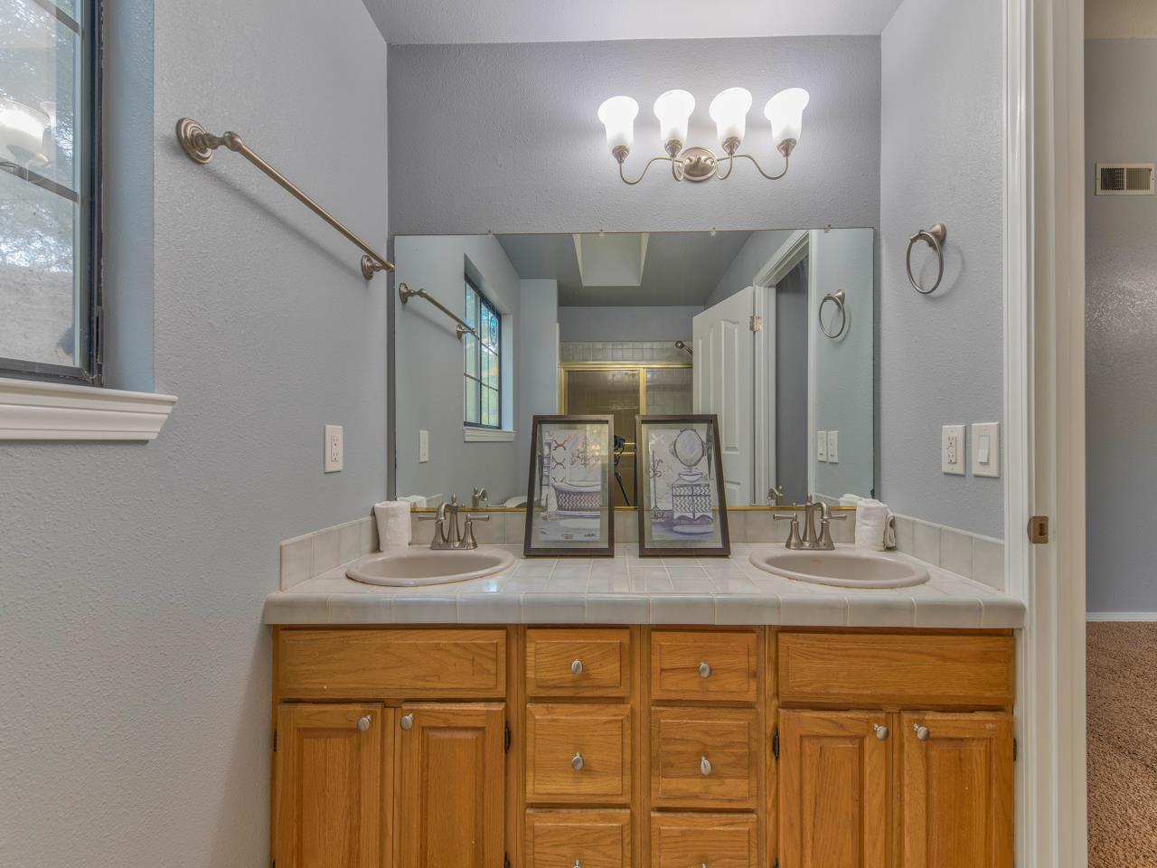 6640 Kim Ann Lane Salinas, CA 93907 - Photo 21 of 41 a bathroom with a granite countertop sink and a mirror