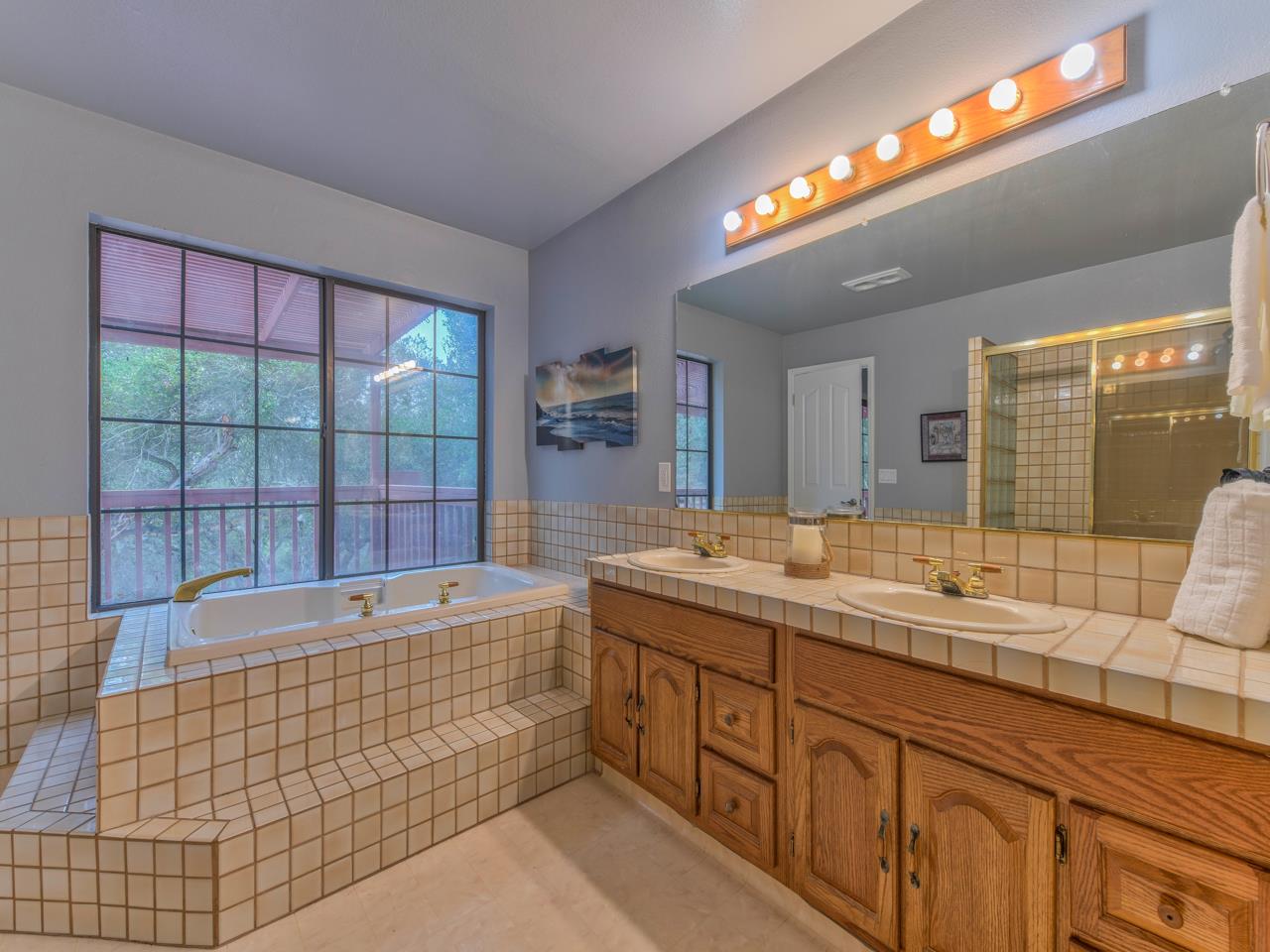 6640 Kim Ann Lane Salinas, CA 93907 - Photo 37 of 41 a bathroom with a tub a double vanity sink a two mirror and a bathtub
