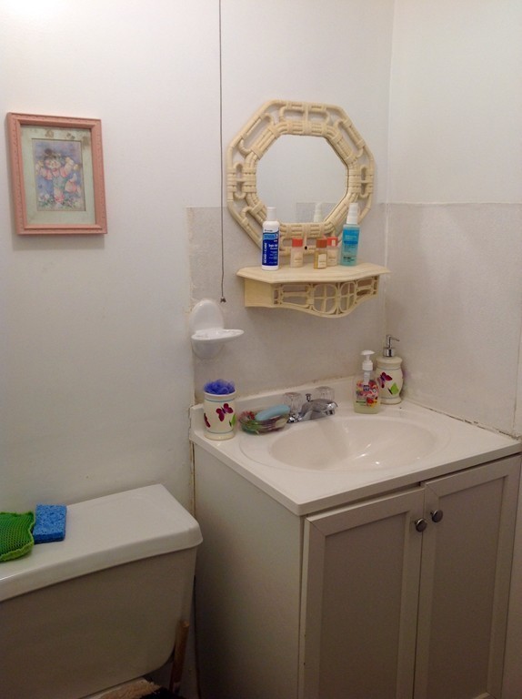 122 Redlands Street Springfield, MA 01104 - Photo 12 of 13 a room with a sink a stove and a mirror