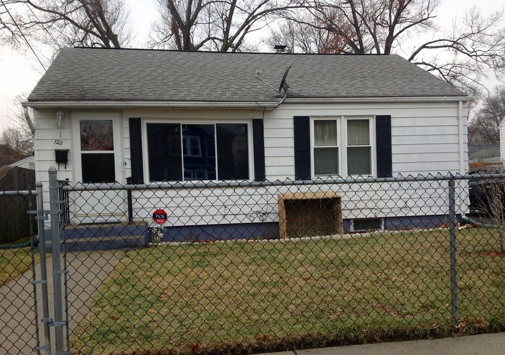 122 Redlands Street Springfield, MA 01104 - Photo 2 of 13 front view of a brick house with a small yard
