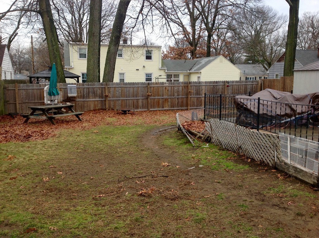 122 Redlands Street Springfield, MA 01104 - Photo 5 of 13 a view of backyard with wooden fence and large trees