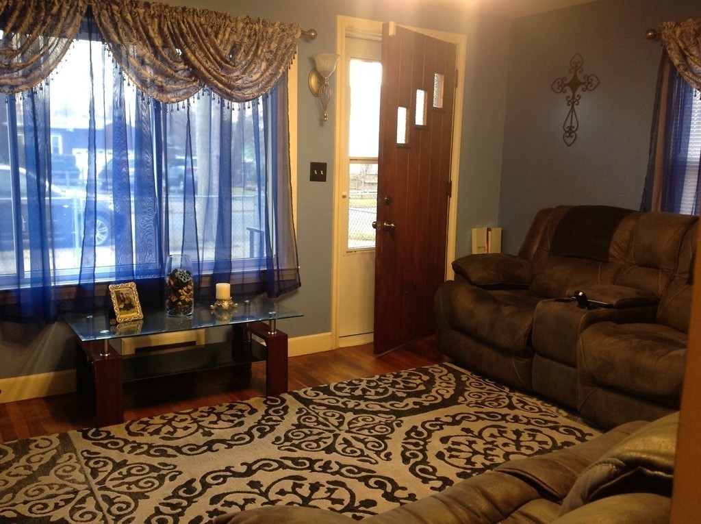 122 Redlands Street Springfield, MA 01104 - Photo 8 of 13 a living room with a couch and a table in it