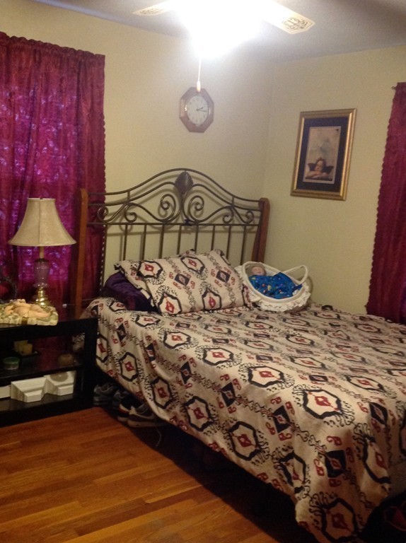 122 Redlands Street Springfield, MA 01104 - Photo 9 of 13 a bedroom with a bed and a lamp