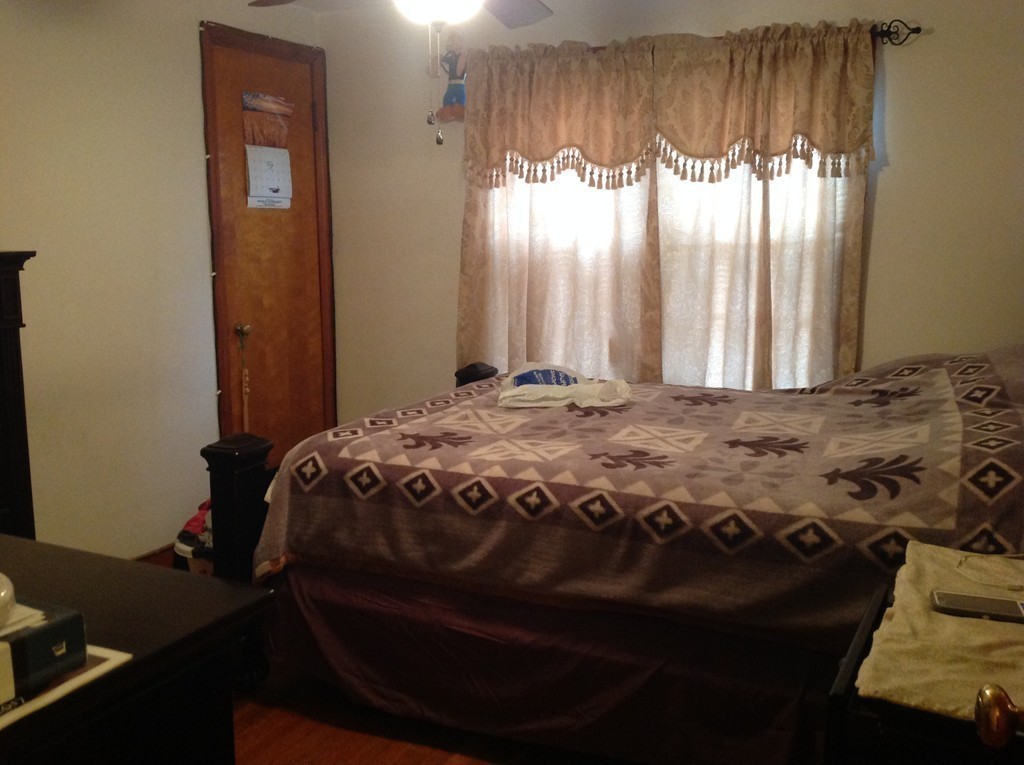 122 Redlands Street Springfield, MA 01104 - Photo 10 of 13 a bedroom with a bed next to a window