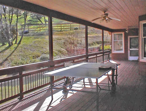 a view of a patio with iron fence