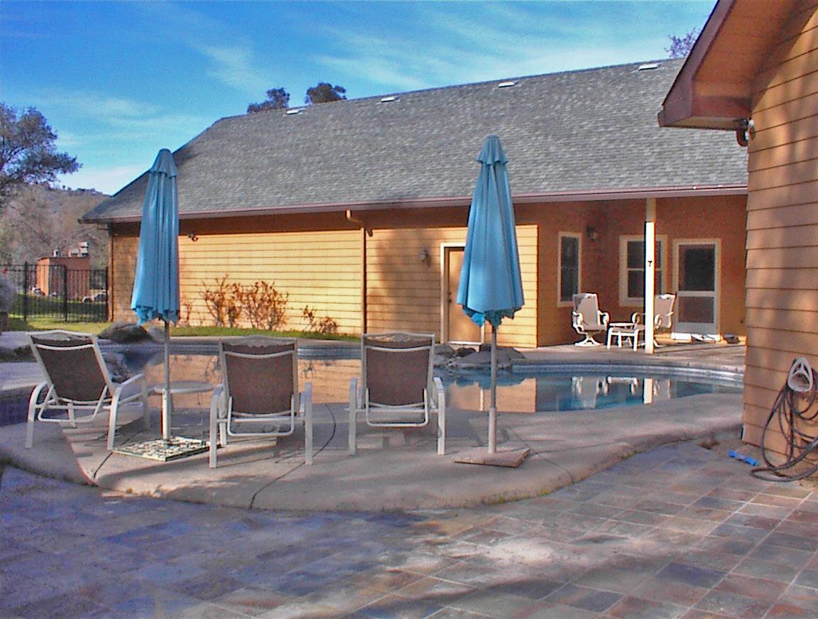 45483 Sand Creek Road Squaw Valley, CA 93675 - Photo 17 of 80 a view of a patio with dining table and chairs with wooden floor and fence