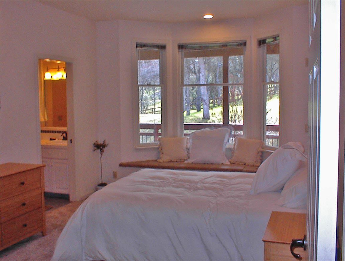 45483 Sand Creek Road Squaw Valley, CA 93675 - Photo 36 of 80 a bedroom with a bed and large windows
