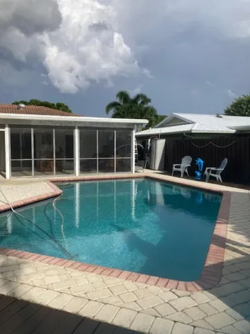 a view of a wooden deck and a yard
