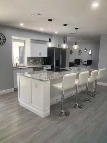 a large kitchen with a table and chairs