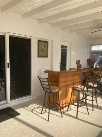 a view of a dining room with furniture and a chandelier