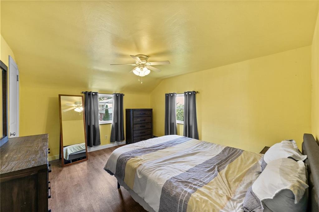 318 Earlwood Road Pittsburgh, PA 15235 - Photo 20 of 33 13'x12' second floor bedroom with luxury vinyl flooring, paddle fan and 2 corner windows
