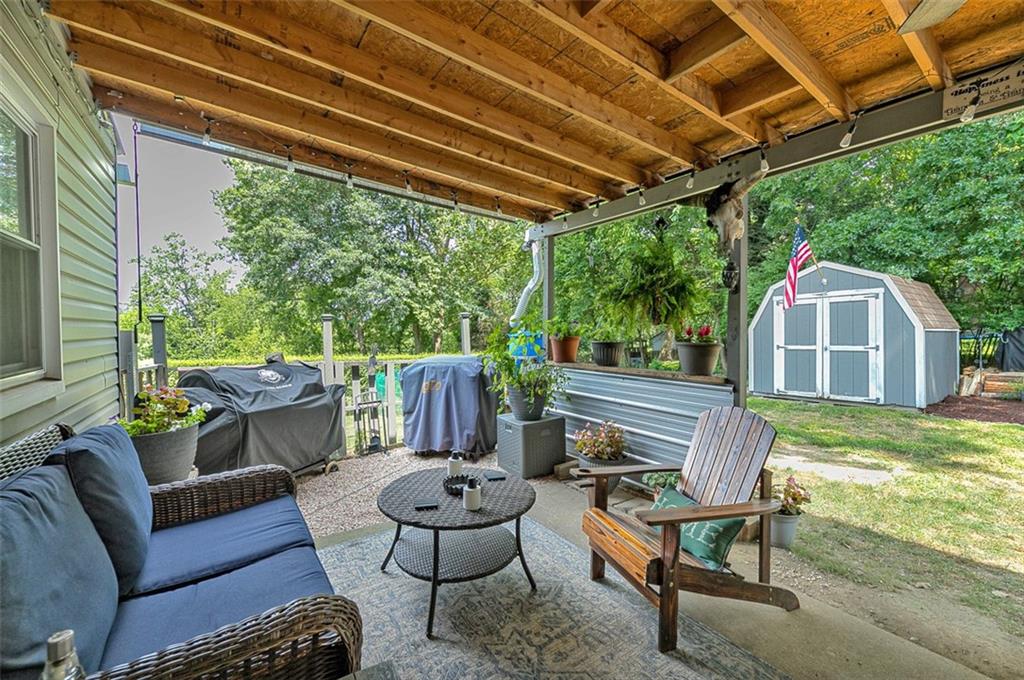 318 Earlwood Road Pittsburgh, PA 15235 - Photo 25 of 33 Step out from the family room to a 28' x 11' covered rear patio and the level rear yard with storage shed