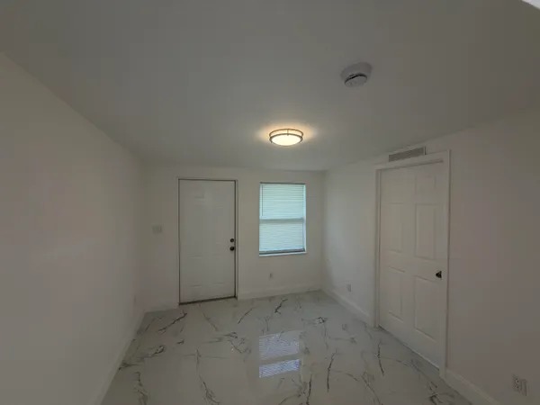 an empty room with white walls