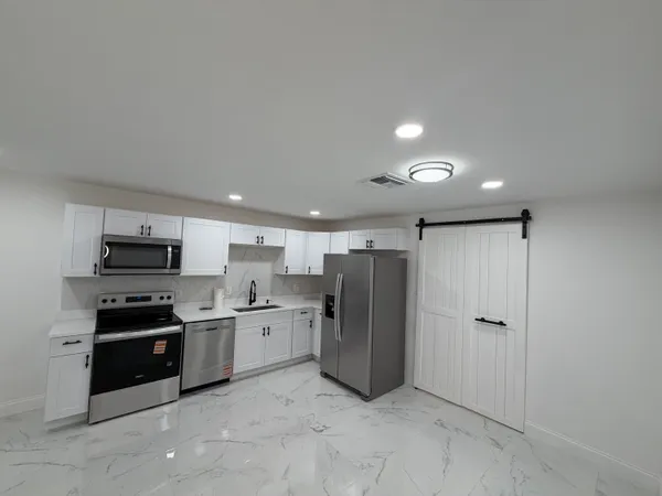a kitchen with stainless steel appliances a refrigerator and a sink