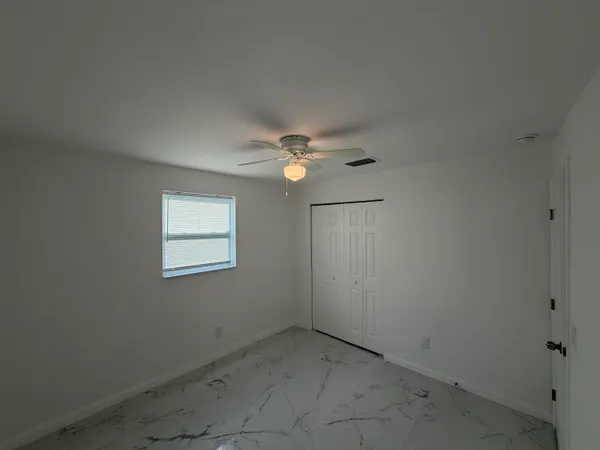 an empty room with a fan
