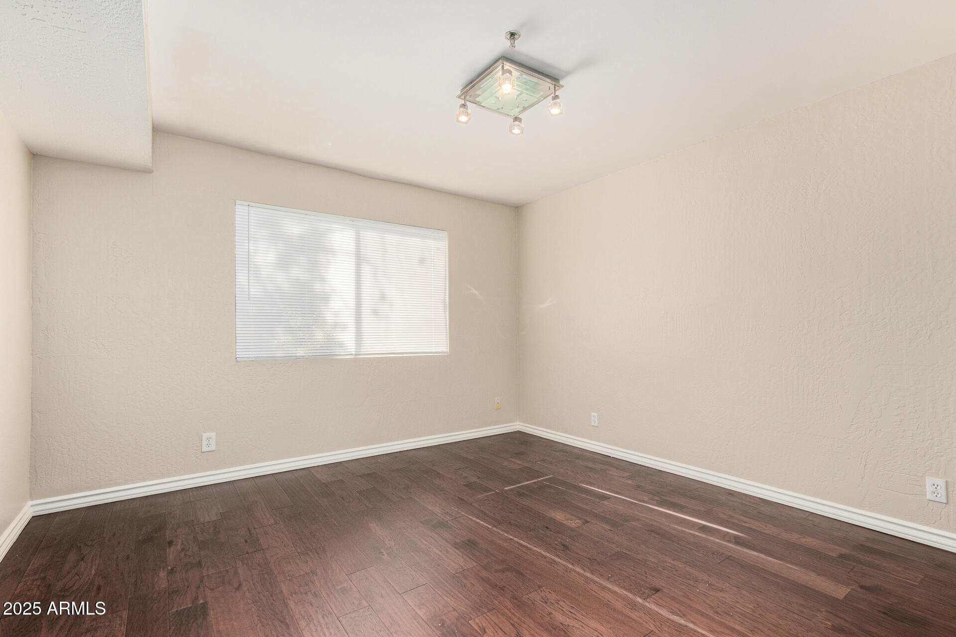 3031 North Civic Center Plaza, Unit 229 Scottsdale, AZ 85251 - Photo 11 of 20 an empty room with wooden floor and windows