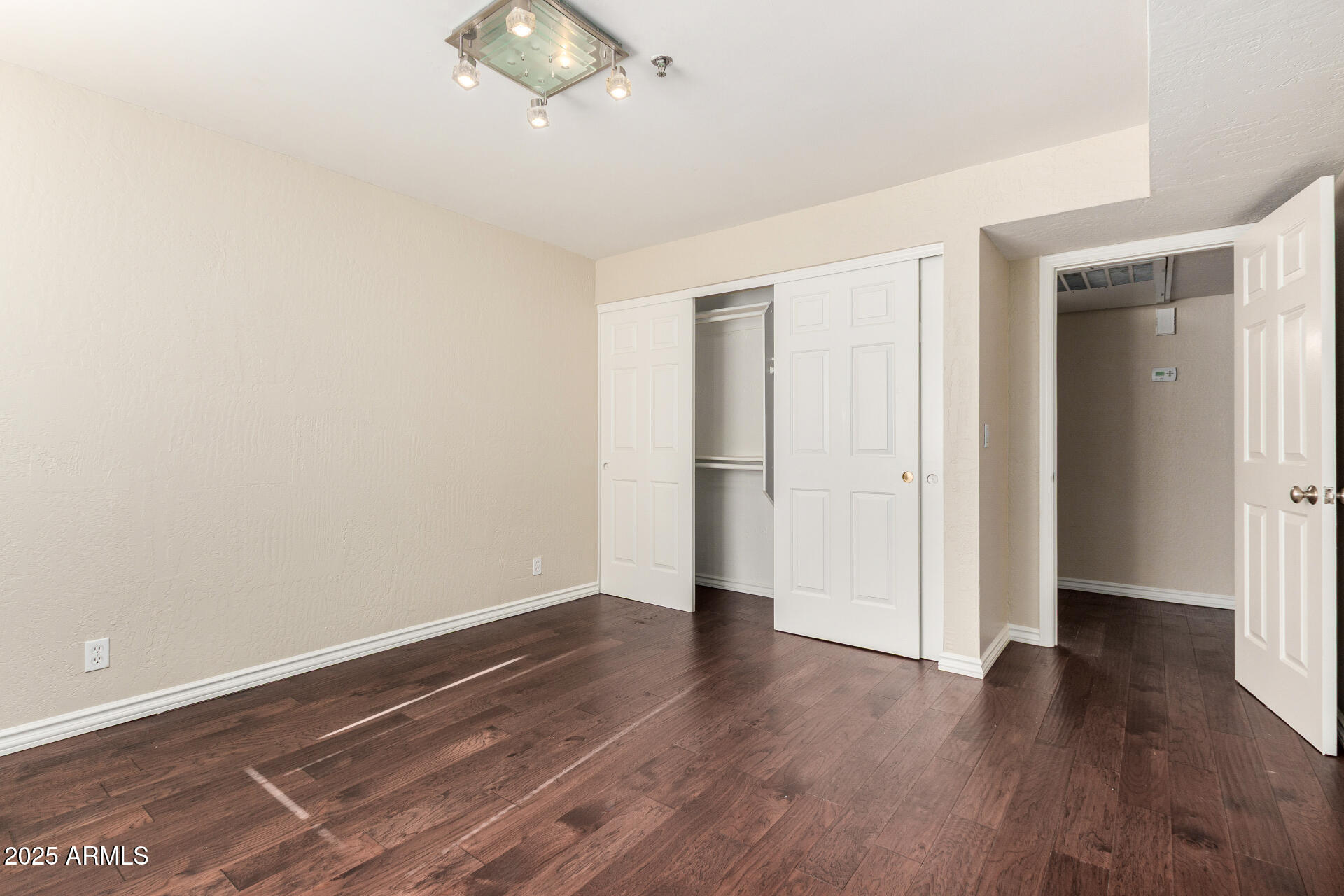 3031 North Civic Center Plaza, Unit 229 Scottsdale, AZ 85251 - Photo 12 of 20 an empty room with wooden floor and ceiling fan