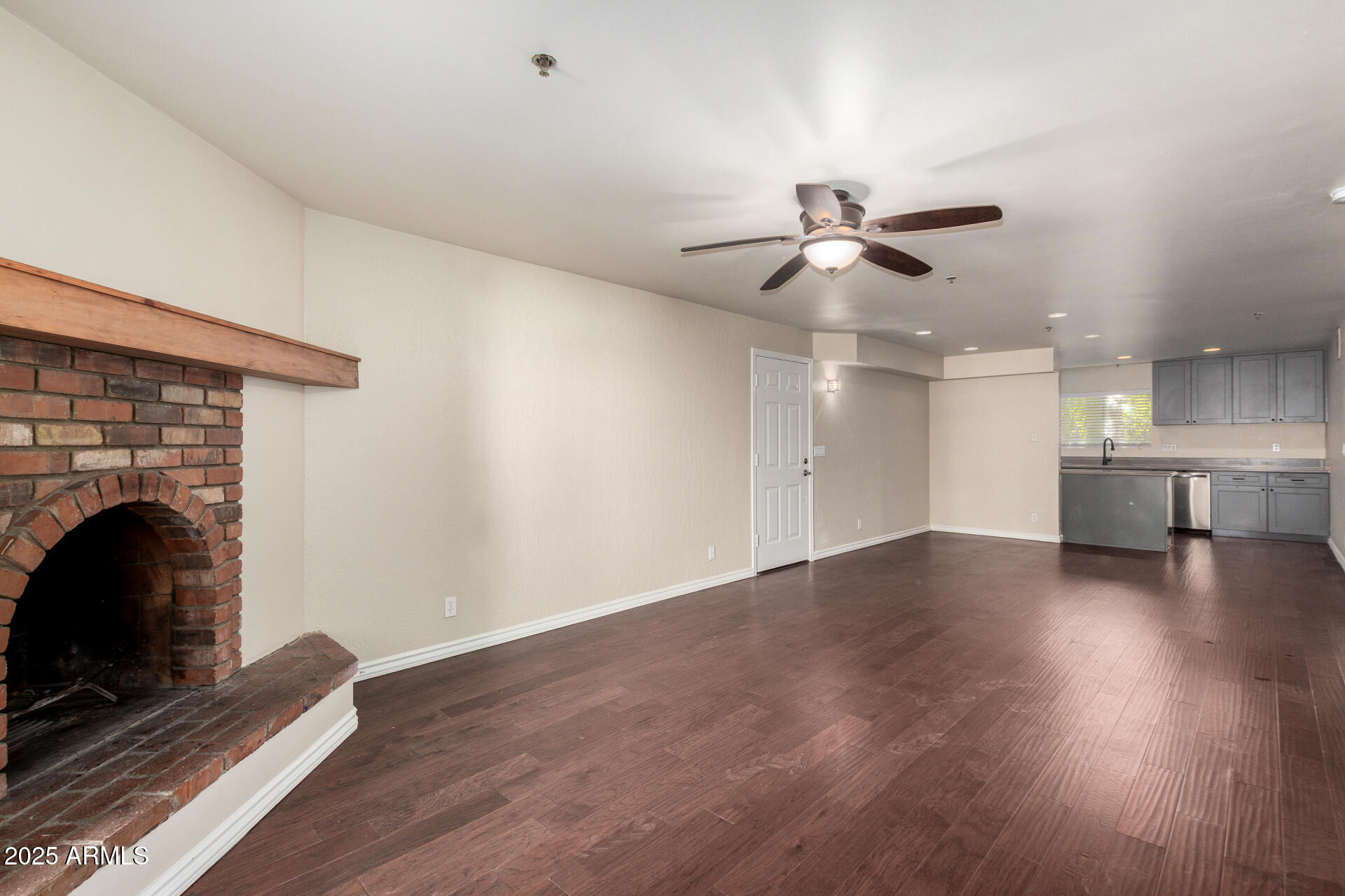 3031 North Civic Center Plaza, Unit 229 Scottsdale, AZ 85251 - Photo 3 of 20 a view of empty room with wooden floor and fireplace