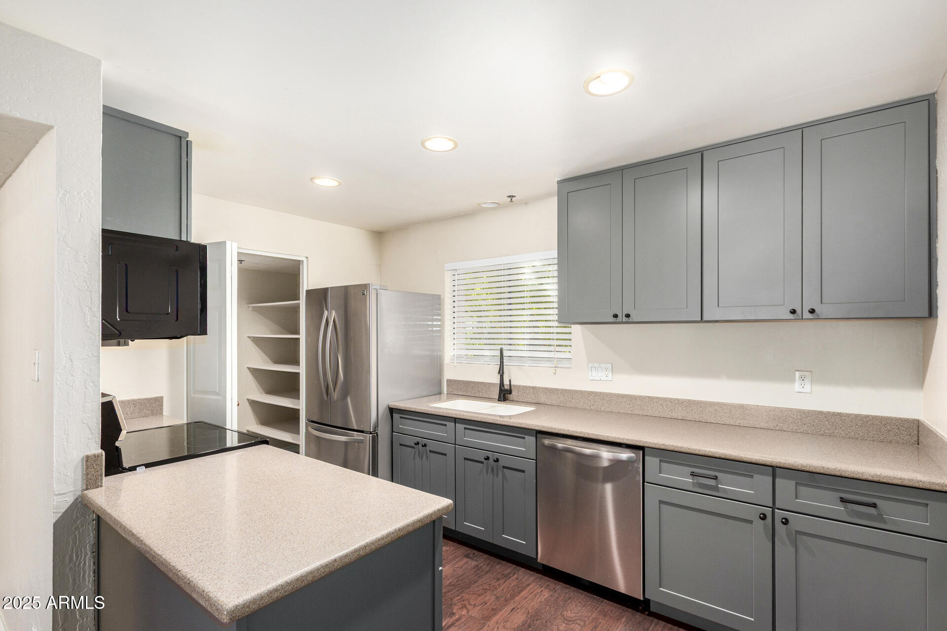 3031 North Civic Center Plaza, Unit 229 Scottsdale, AZ 85251 - Photo 4 of 20 a kitchen with stainless steel appliances a sink a stove a refrigerator cabinets and a counter top space