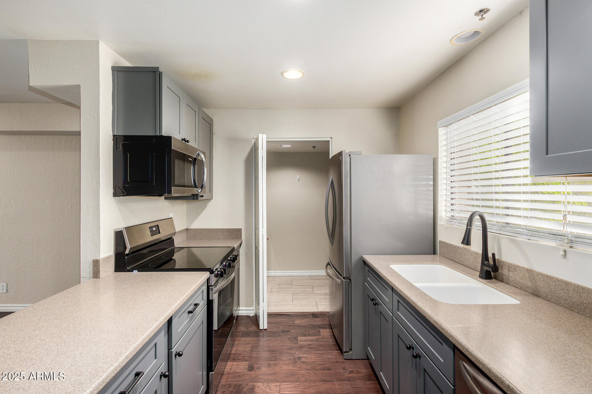 3031 North Civic Center Plaza, Unit 229 Scottsdale, AZ 85251 - Photo 5 of 20 a kitchen with a sink a stove and refrigerator