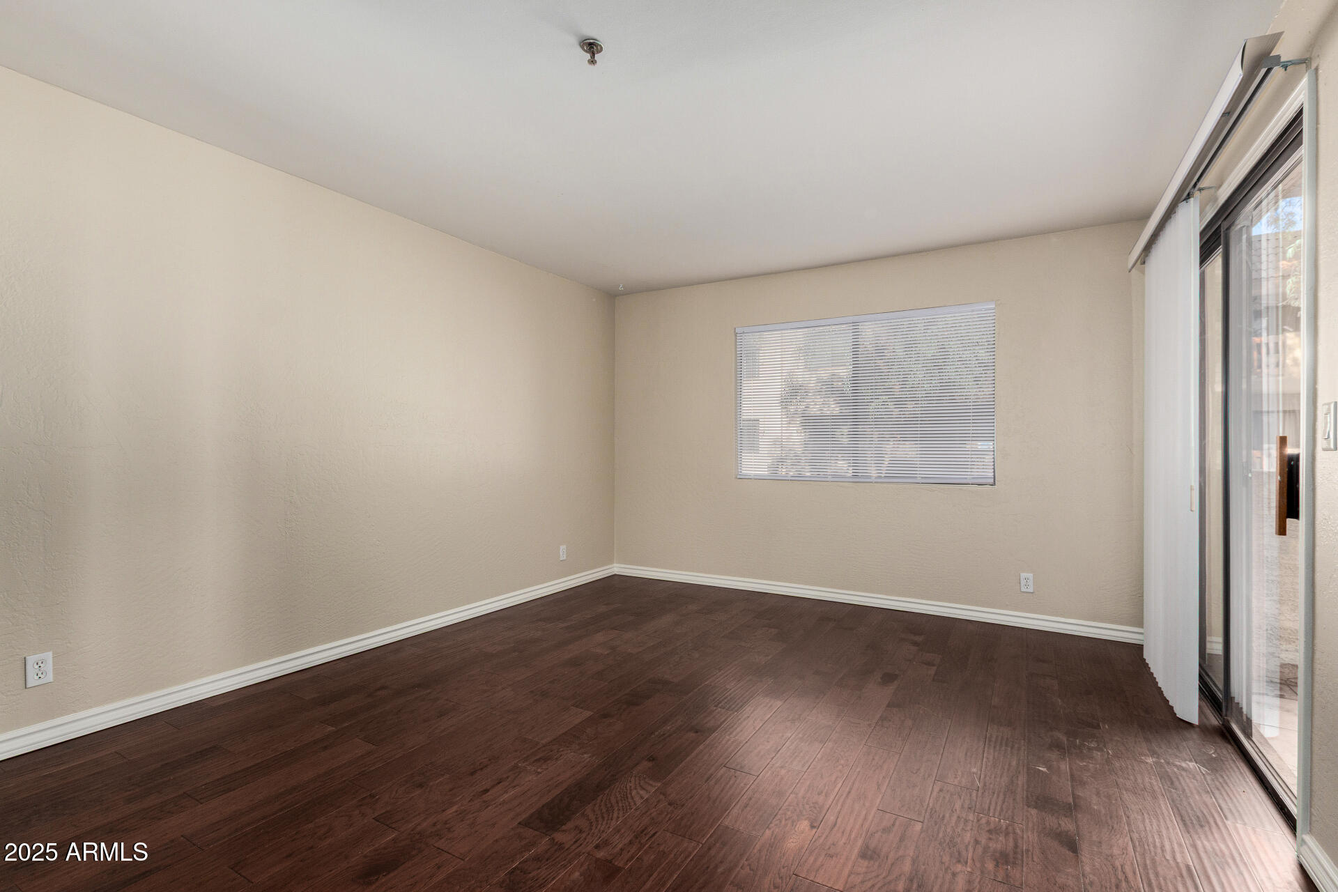 3031 North Civic Center Plaza, Unit 229 Scottsdale, AZ 85251 - Photo 6 of 20 an empty room with wooden floor and windows
