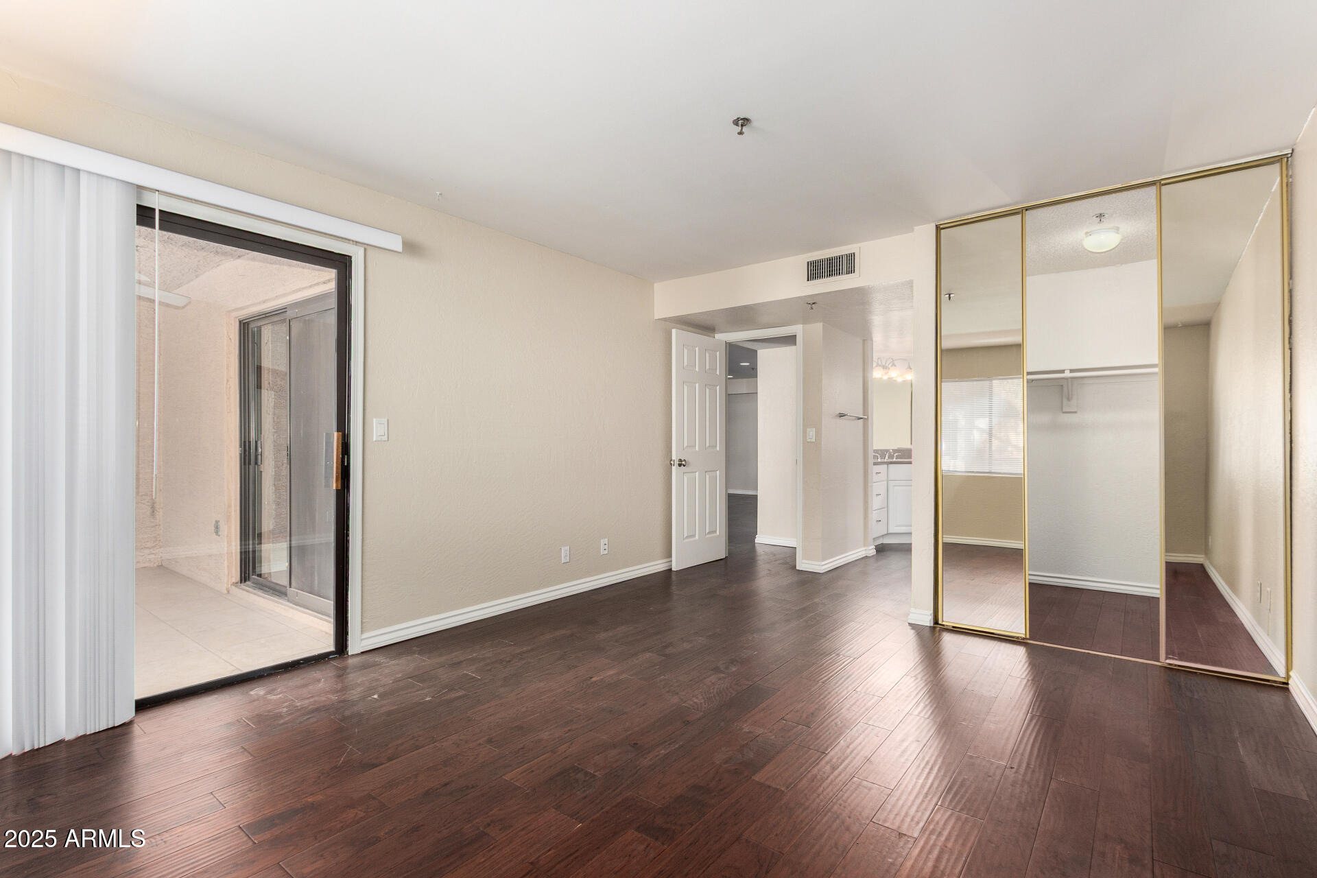3031 North Civic Center Plaza, Unit 229 Scottsdale, AZ 85251 - Photo 7 of 20 a view of an empty room with wooden floor
