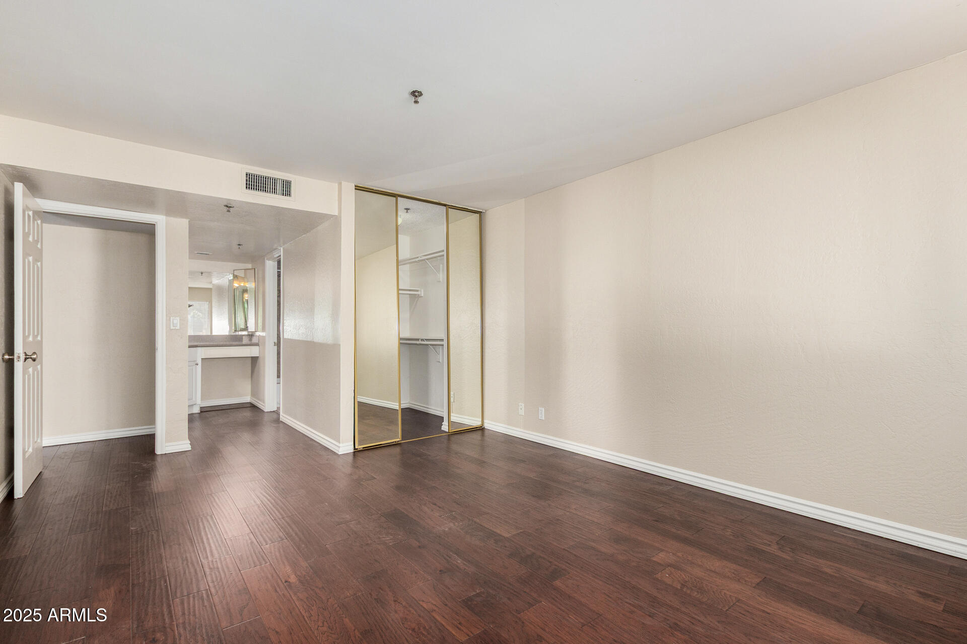 3031 North Civic Center Plaza, Unit 229 Scottsdale, AZ 85251 - Photo 8 of 20 a view of an empty room with wooden floor