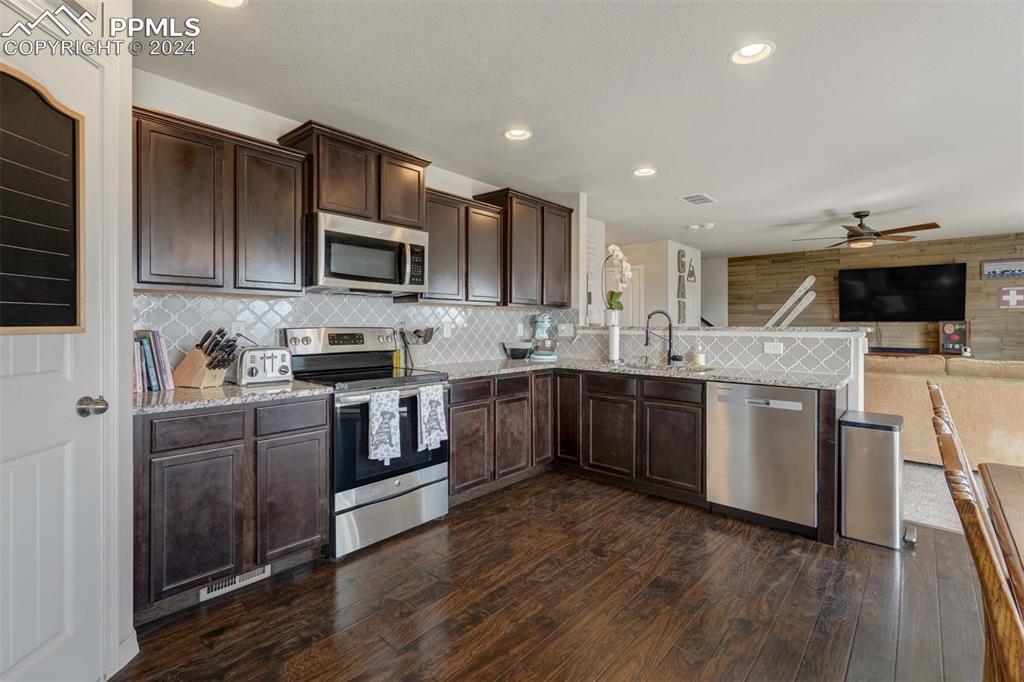 11305 Avena Road Peyton, CO 80831 - Photo 11 of 47 a kitchen with a sink cabinets and stainless steel appliances