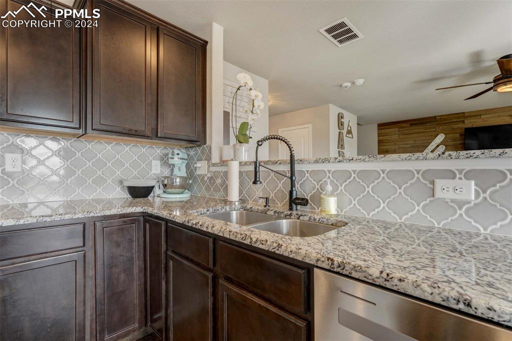 11305 Avena Road Peyton, CO 80831 - Photo 13 of 47 a kitchen with granite countertop a sink stainless steel appliances and cabinets