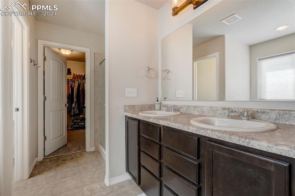11305 Avena Road Peyton, CO 80831 - Photo 22 of 47 a bathroom with a sink and a mirror