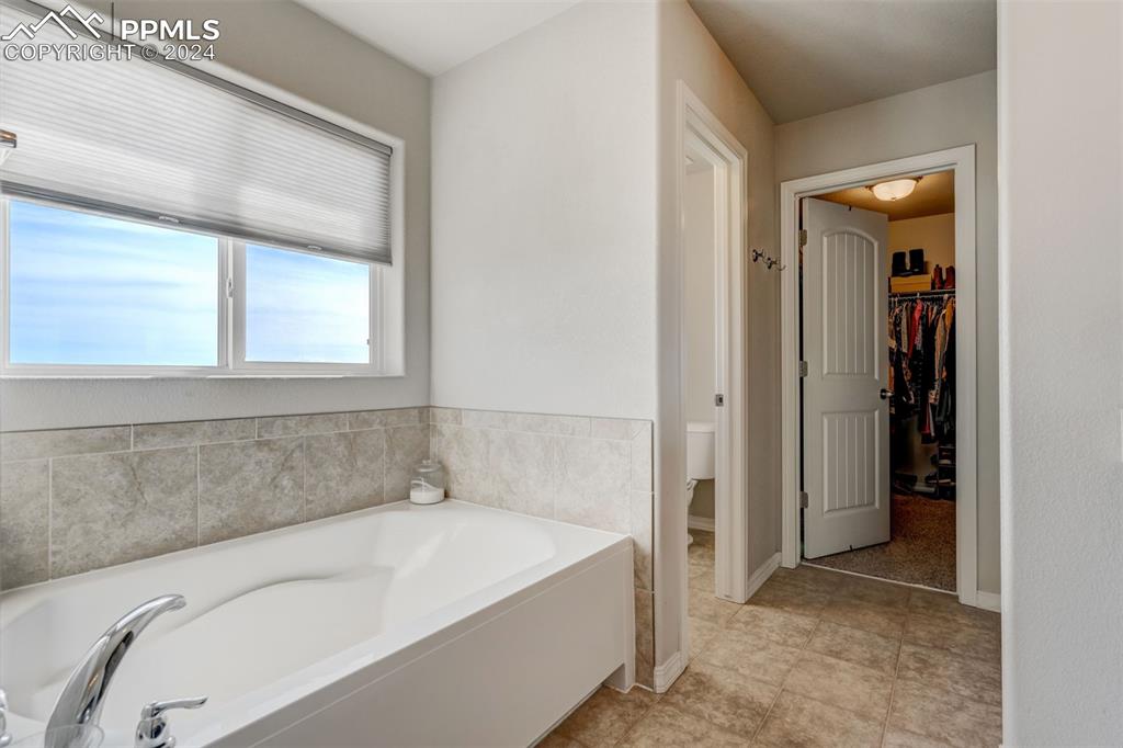 11305 Avena Road Peyton, CO 80831 - Photo 23 of 47 a white bath tub sitting in a bathroom