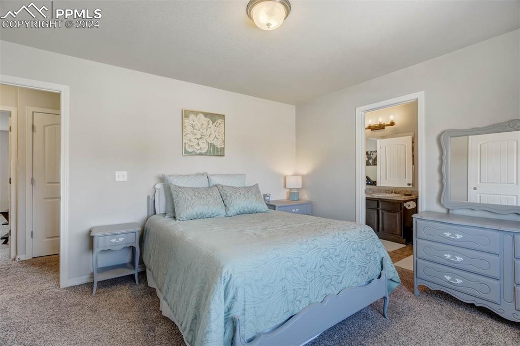 11305 Avena Road Peyton, CO 80831 - Photo 28 of 47 a bedroom with a bed and a dresser