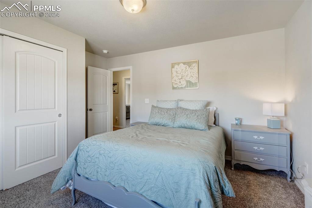 11305 Avena Road Peyton, CO 80831 - Photo 29 of 47 a bedroom with a bed and a window