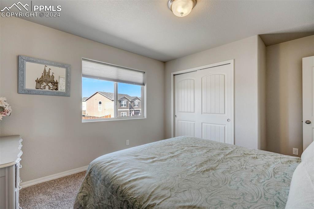 11305 Avena Road Peyton, CO 80831 - Photo 30 of 47 a bedroom with a bed and a window