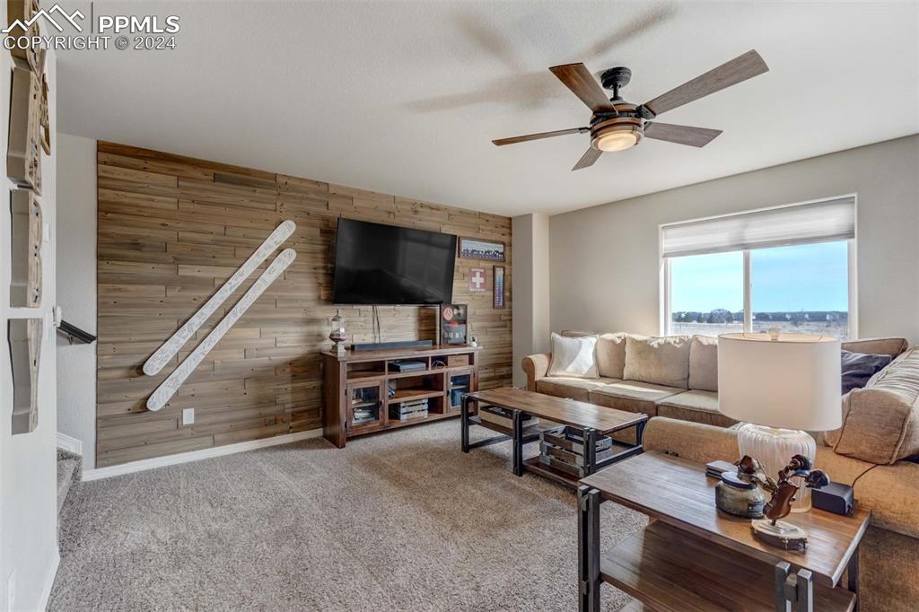 11305 Avena Road Peyton, CO 80831 - Photo 4 of 47 a living room with furniture and a flat screen tv